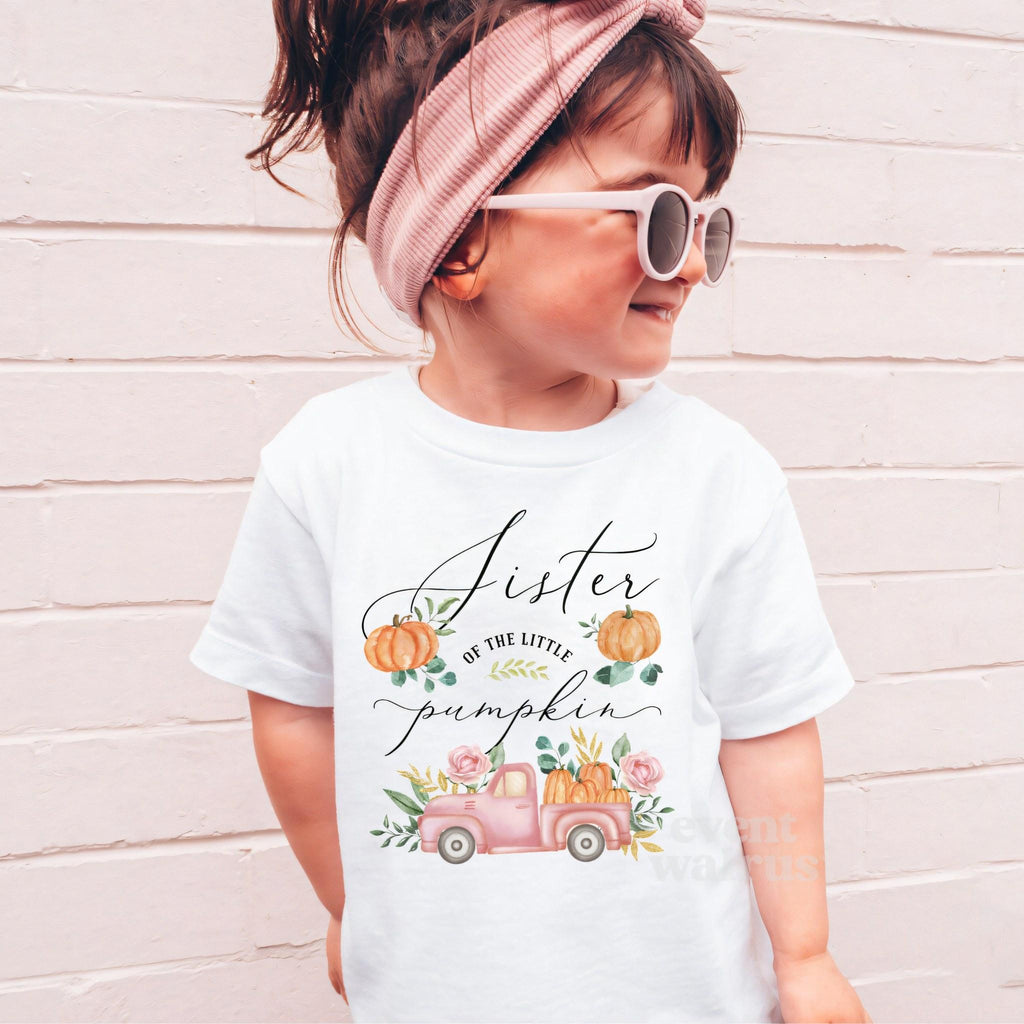 Girl in sunglasses and a pink headband wearing a white Sister of the Little Pumpkin shirt.