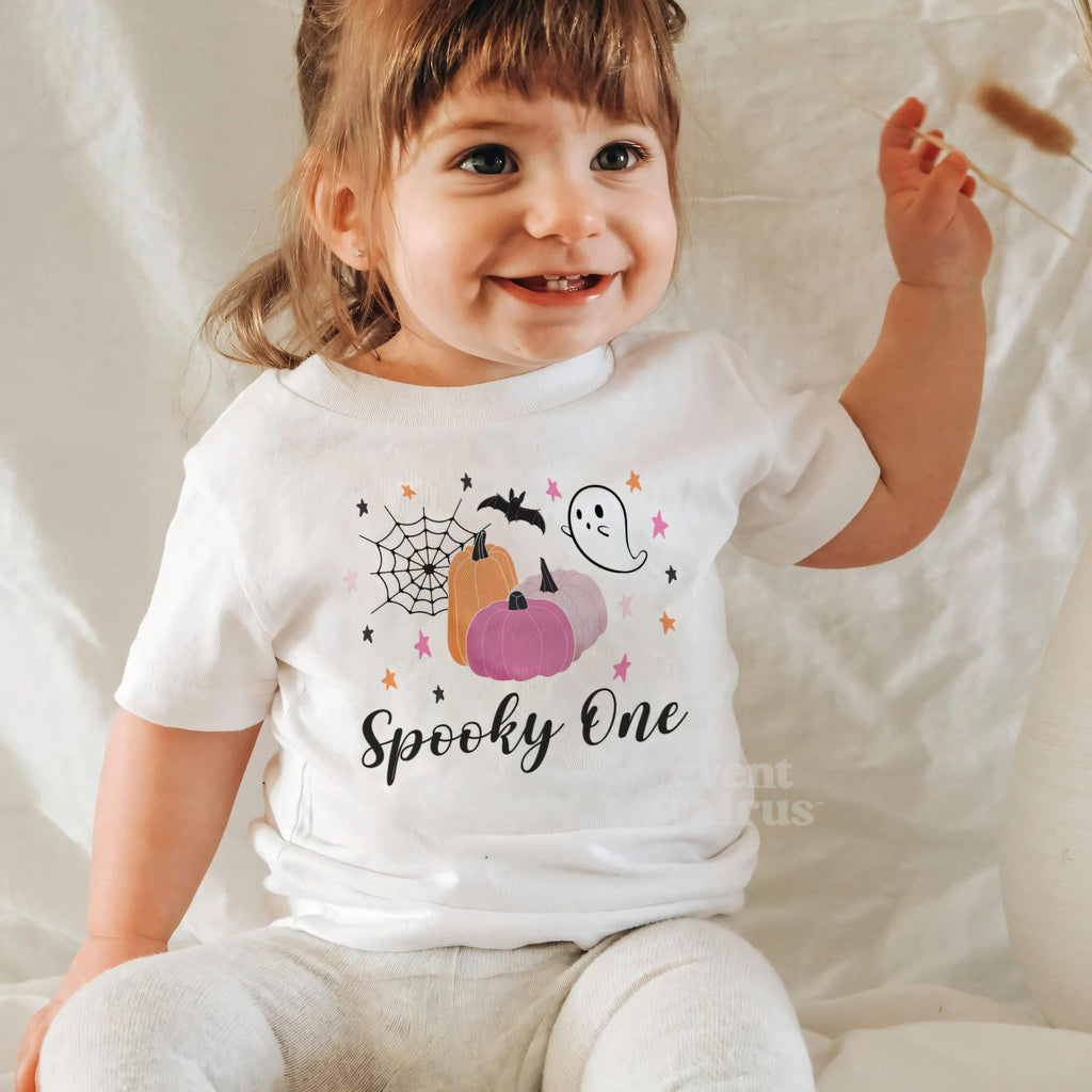 Laughing baby girl in a white Spooky One baby tee.
