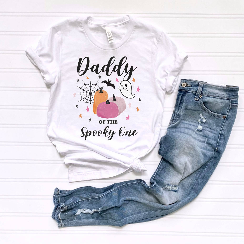 White Daddy of the Spooky One tee laid flat beside jeans.