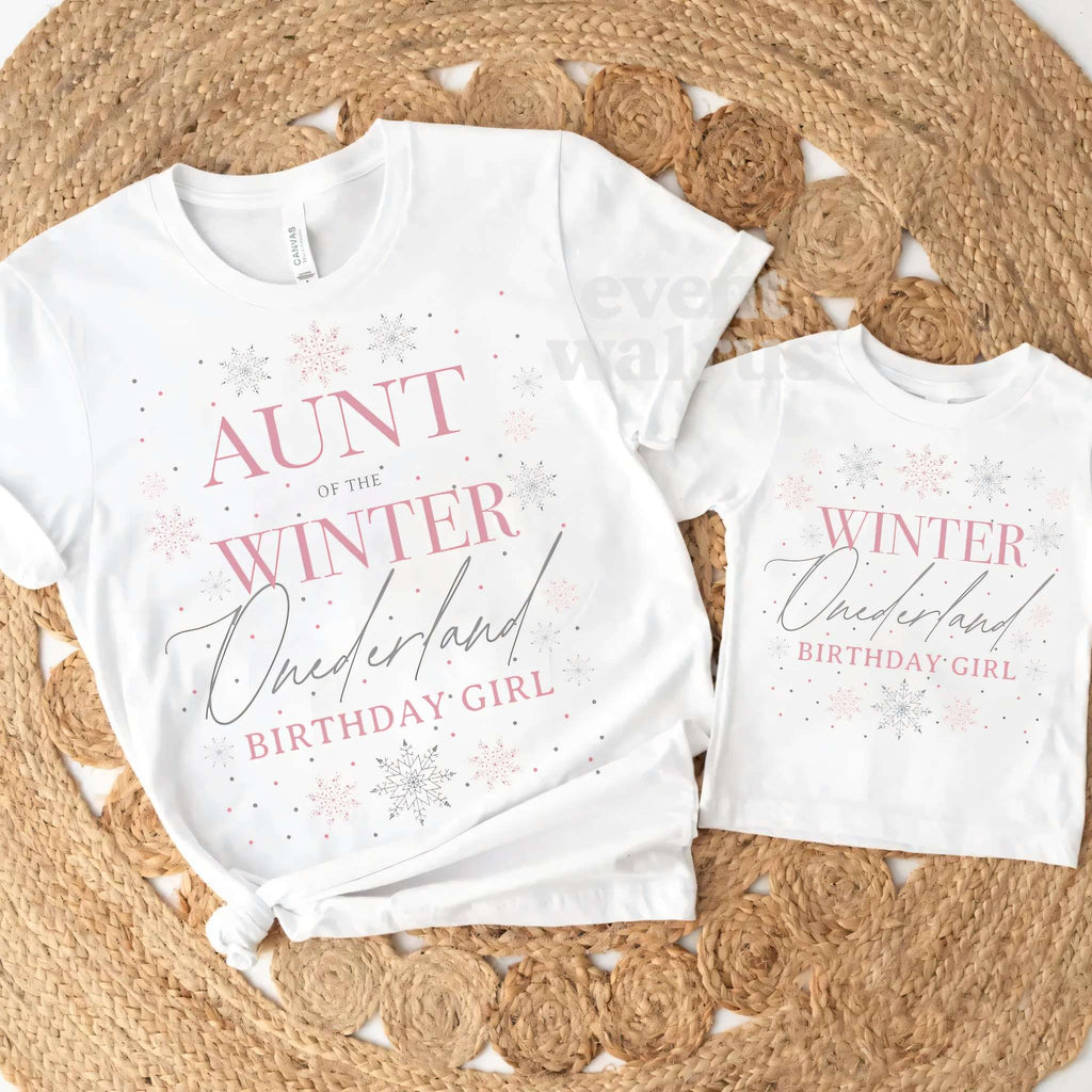 White Aunt and Cousin Winter Onederland Birthday Girl tees on a round jute rug.