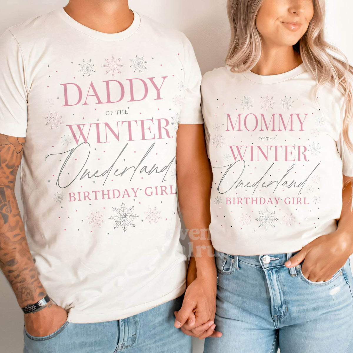 Dad and Mom holding hands in white Daddy and Mommy Winter Onederland shirts.