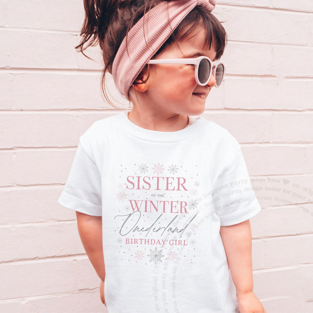 Girl in sunglasses and a pink headband wearing a white Sister of the Winter Onederland shirt.