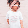 Girl in sunglasses and a pink headband wearing a white Sister of the Winter Onederland shirt.