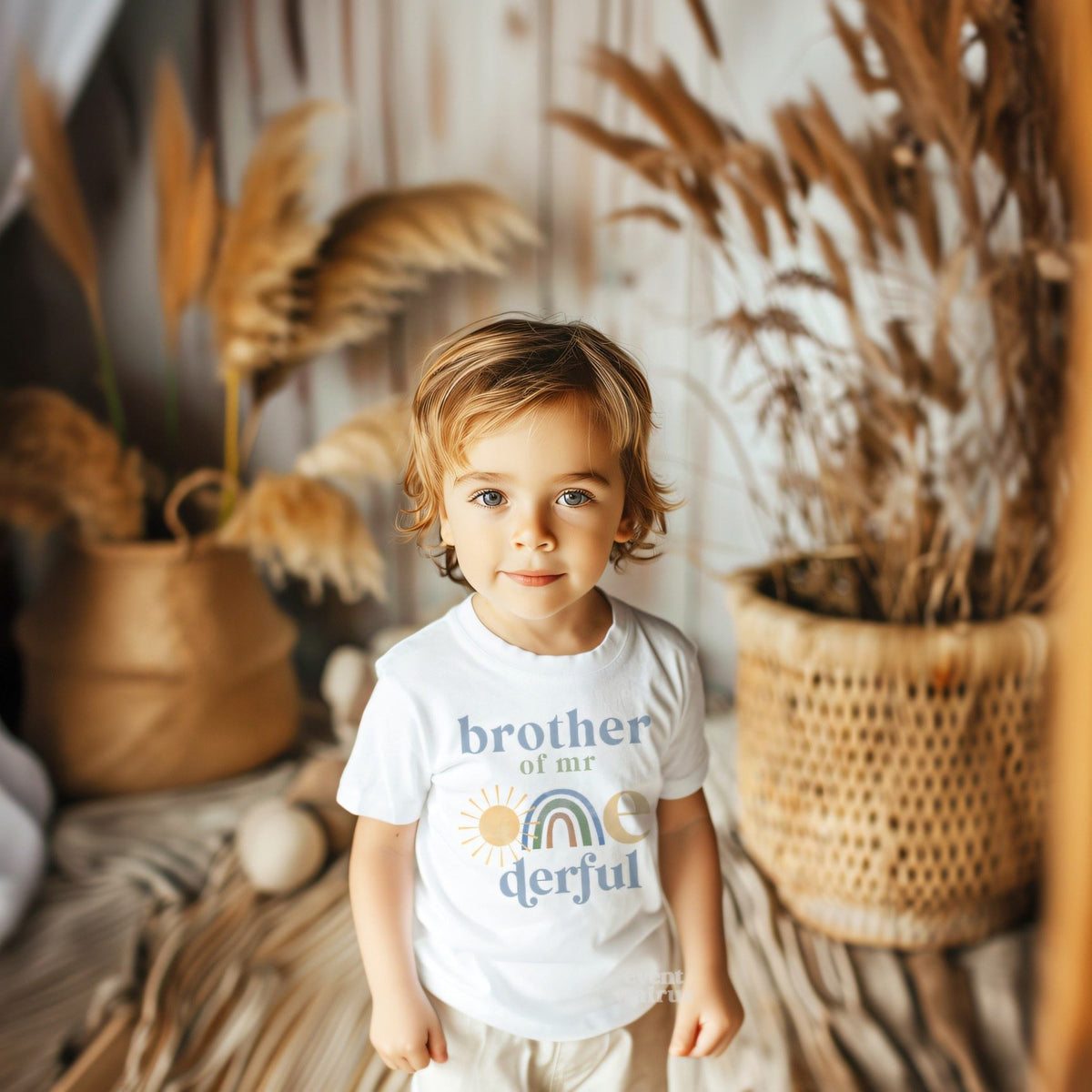 Little boy in a boho room wearing a white Brother of Mr Onederful tee.