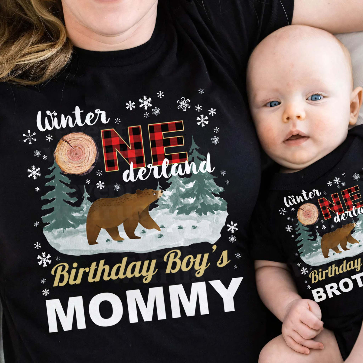 Baby in a black Brother bodysuit cuddled up with Mom in a black Mommy shirt.