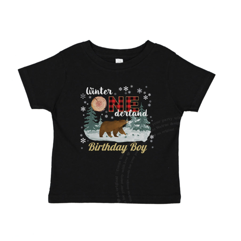 Black baby Birthday Boy tee with the woodland bear and snowy pines, laid flat.