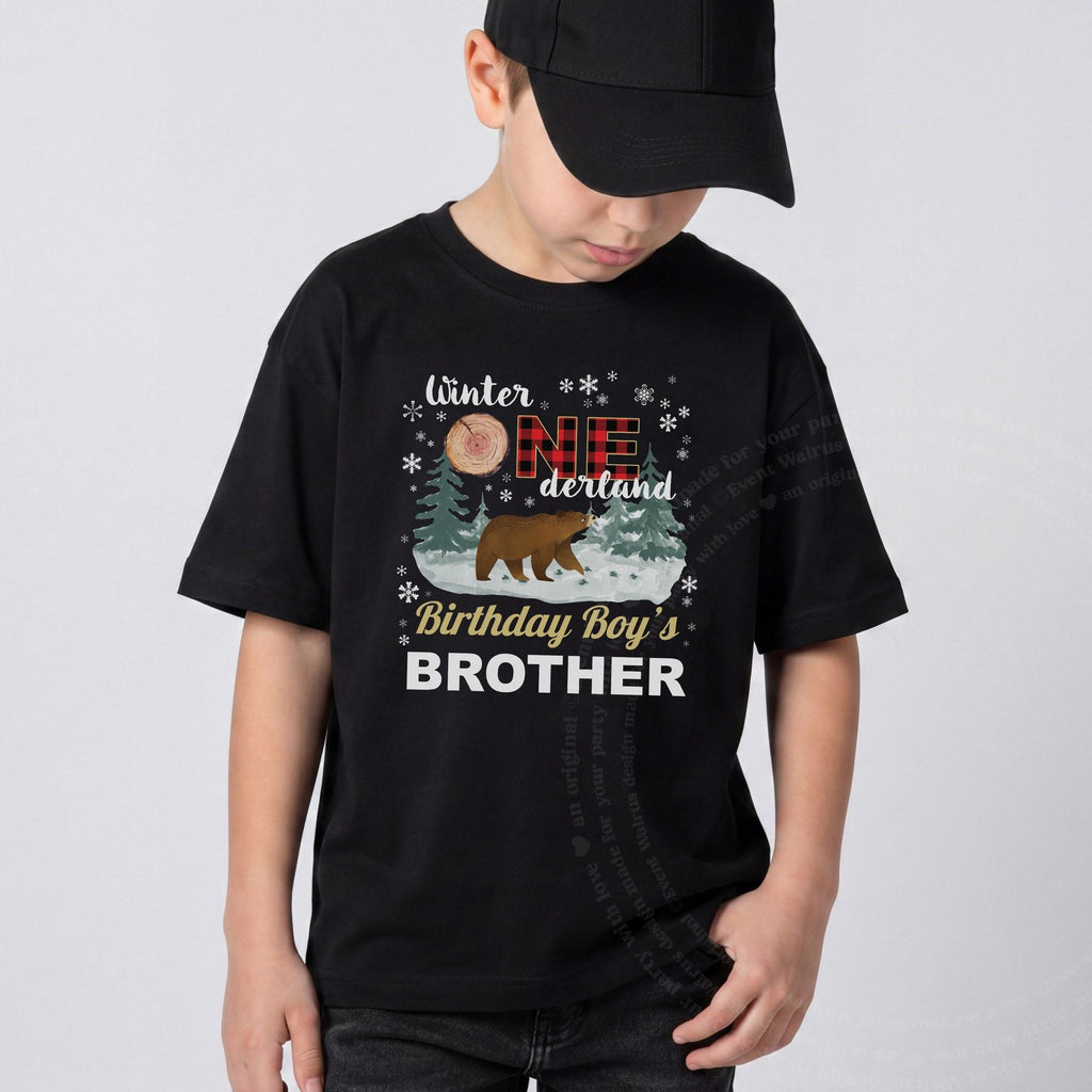 Boy in a black cap wearing a black Winter Onederland Birthday Boy's Brother shirt.