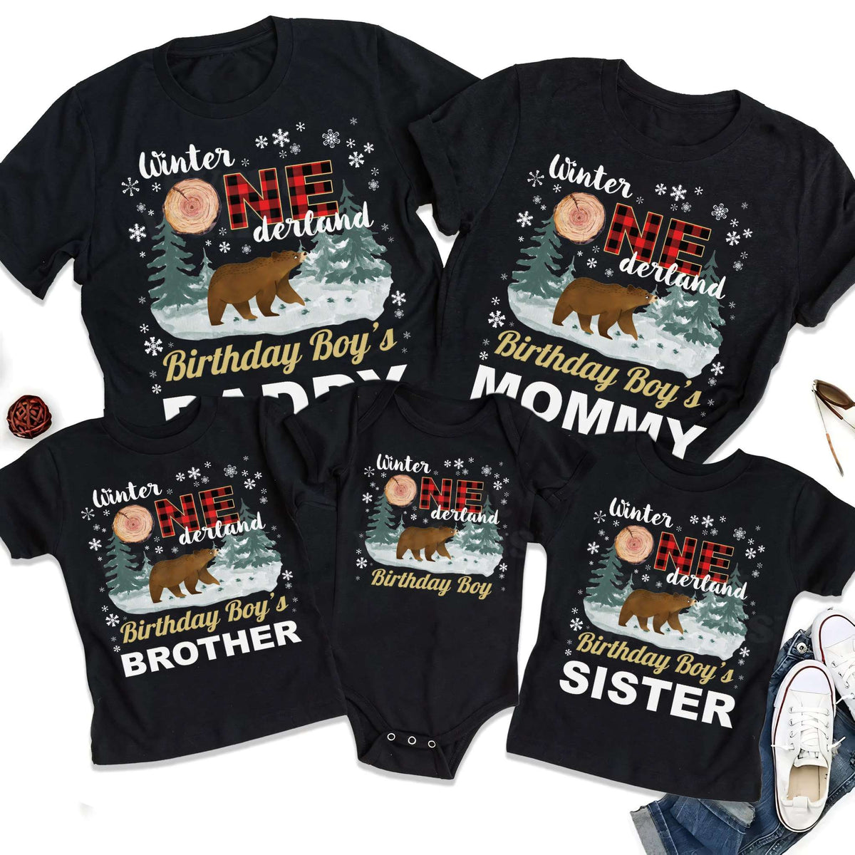 Black Brother and Sister Winter Onederland shirts laid out with the family set.