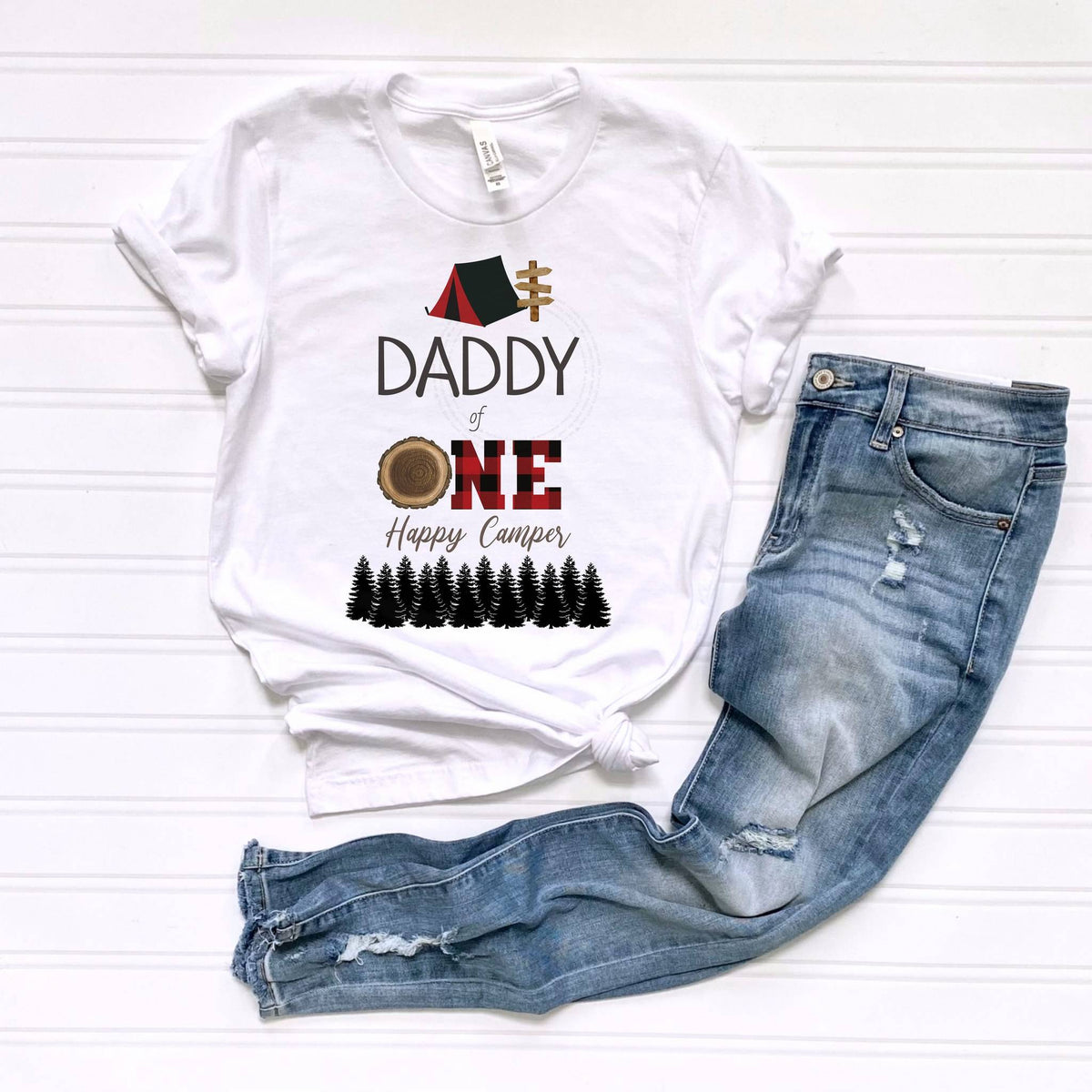 White Daddy of One Happy Camper tee laid flat beside jeans.