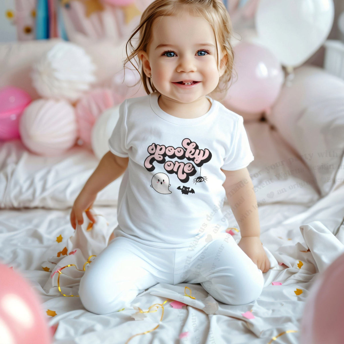 Smiling toddler girl among pink balloons in a white retro pink Spooky One tee.