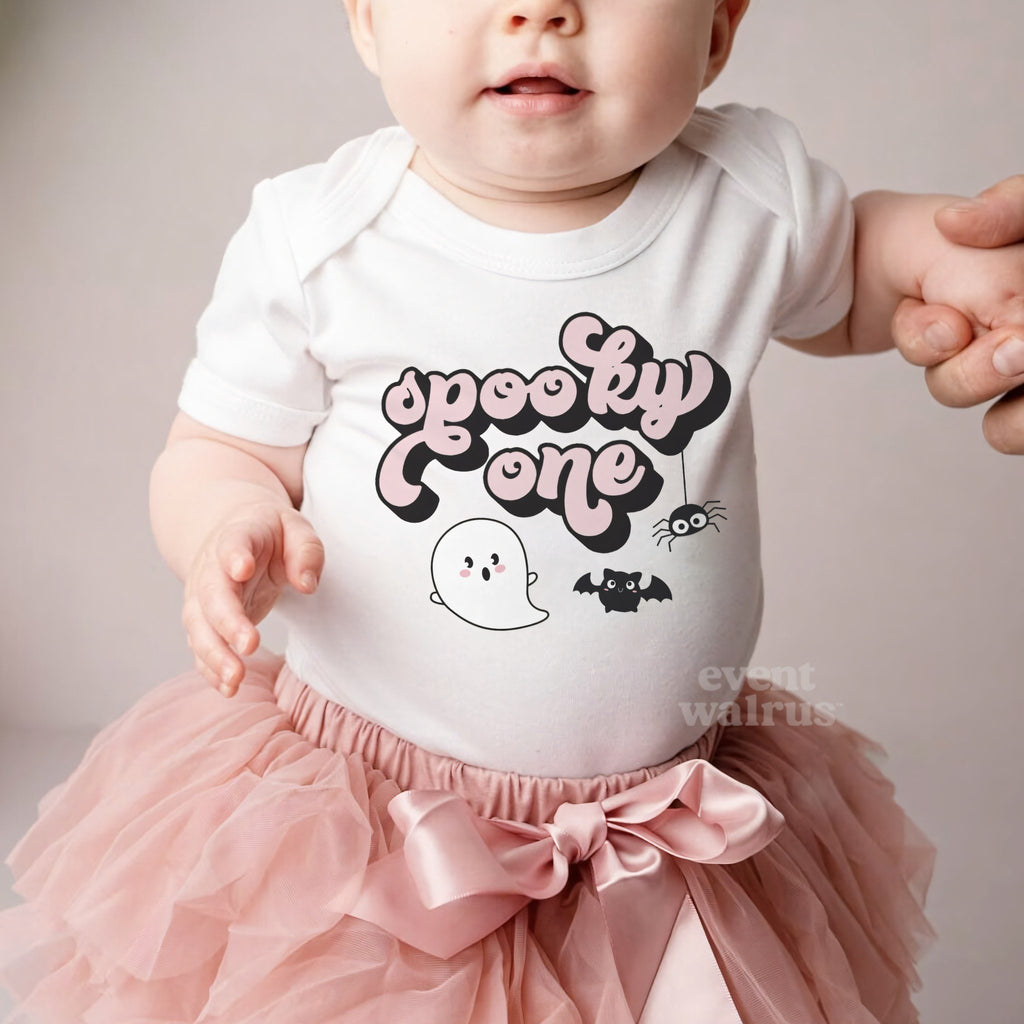 Baby girl in a pink tutu and a white Spooky One bodysuit.