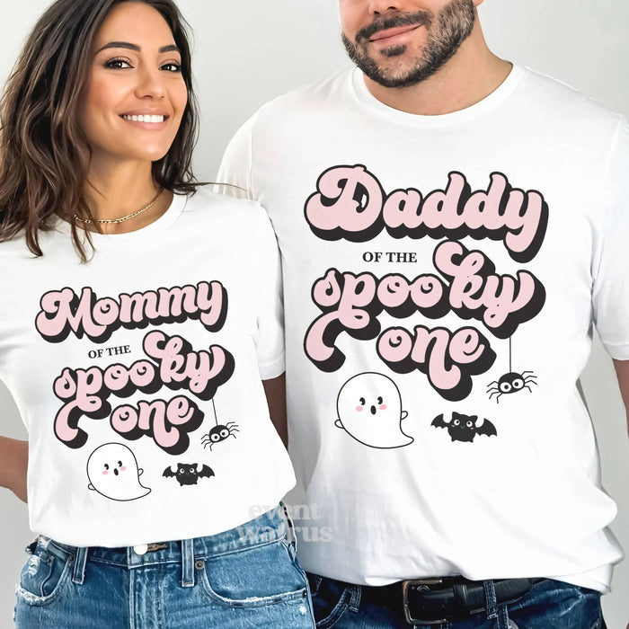 Mom and Dad smiling in white Mommy and Daddy retro pink Spooky One shirts.