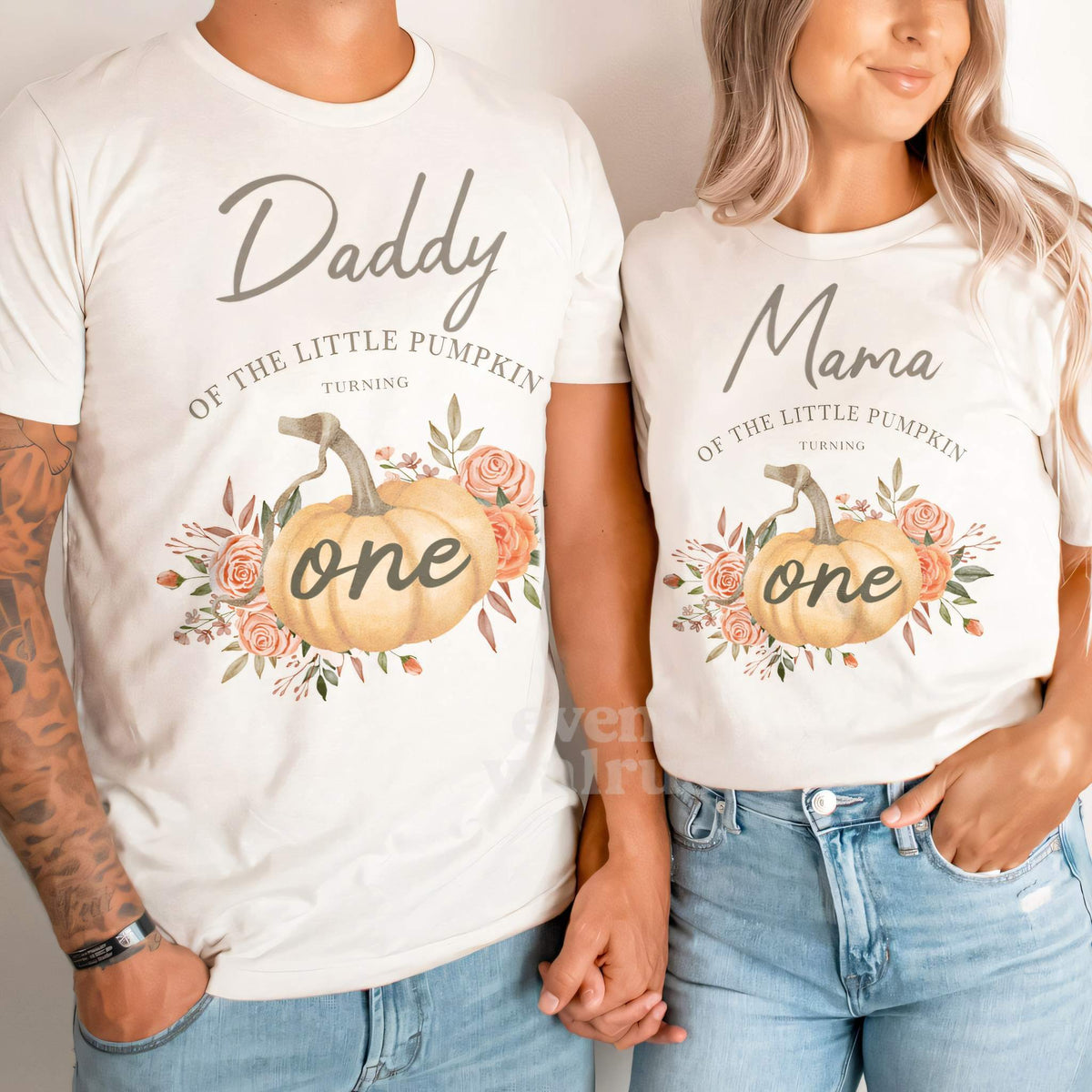 Dad and Mom holding hands in white Daddy and Mama rustic Little Pumpkin shirts.