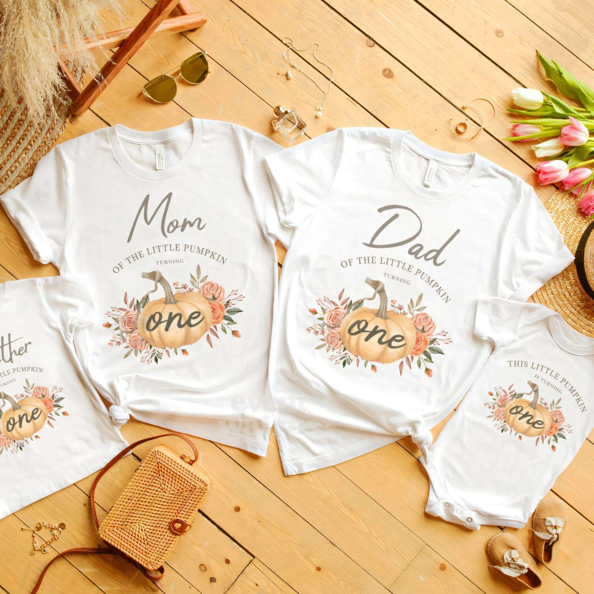 Mom, Dad, Brother and baby rustic Little Pumpkin shirts laid out with tulips.