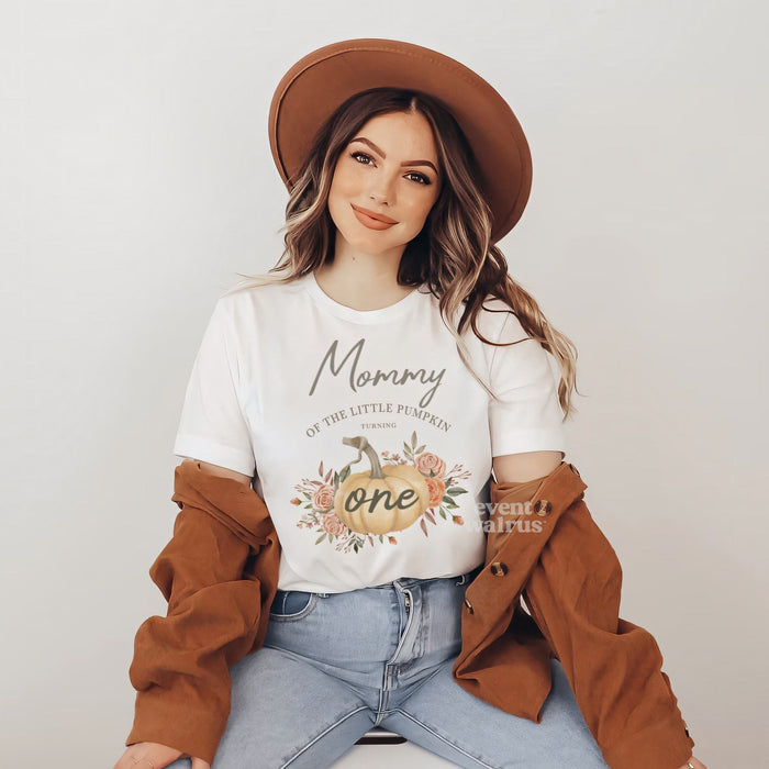Smiling woman in a brown hat wearing a Mommy of the Little Pumpkin shirt with a rustic pumpkin.