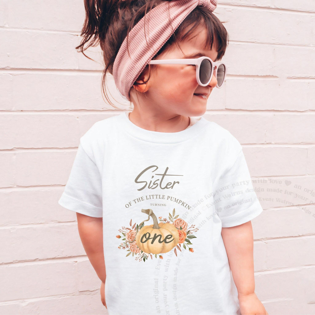 Girl in sunglasses and a pink headband wearing a white Sister of the Little Pumpkin shirt.