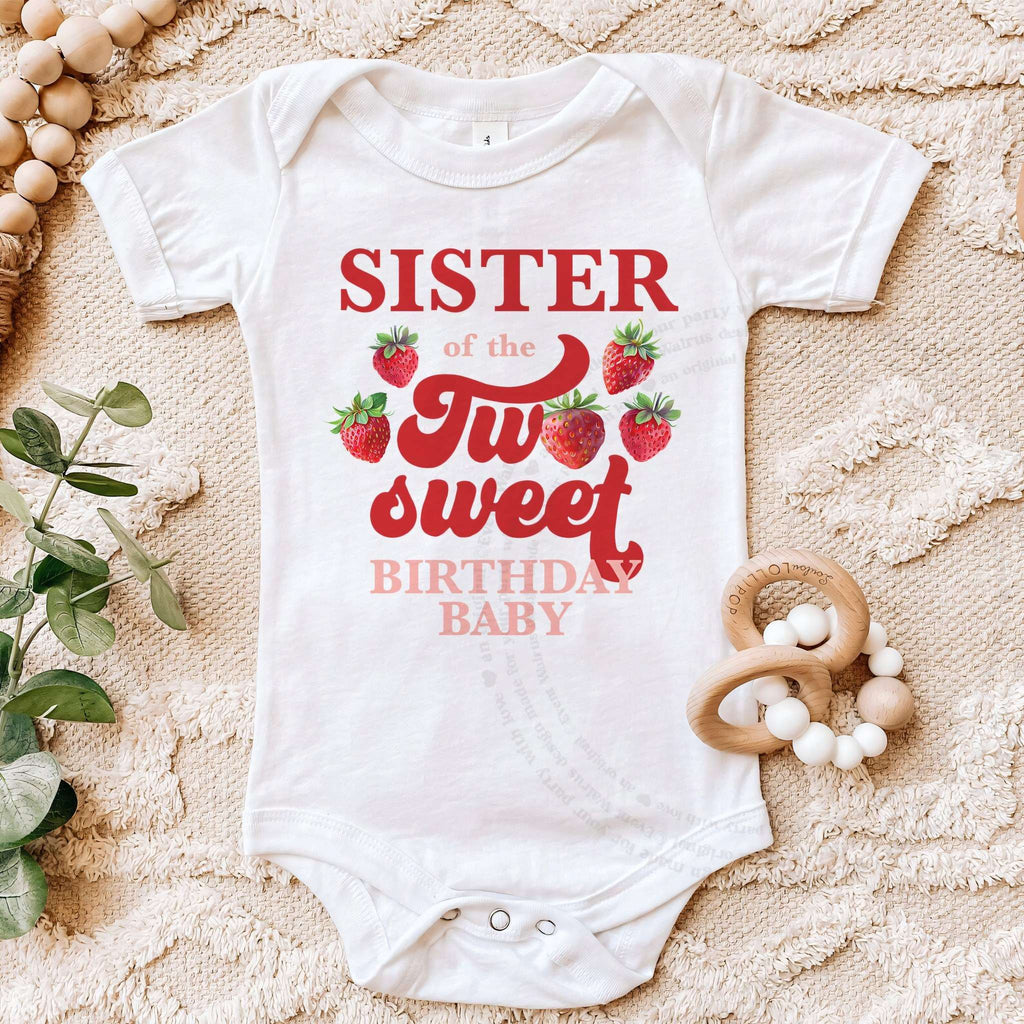 White Sister of the Two Sweet bodysuit on a beige blanket with a wooden teether.