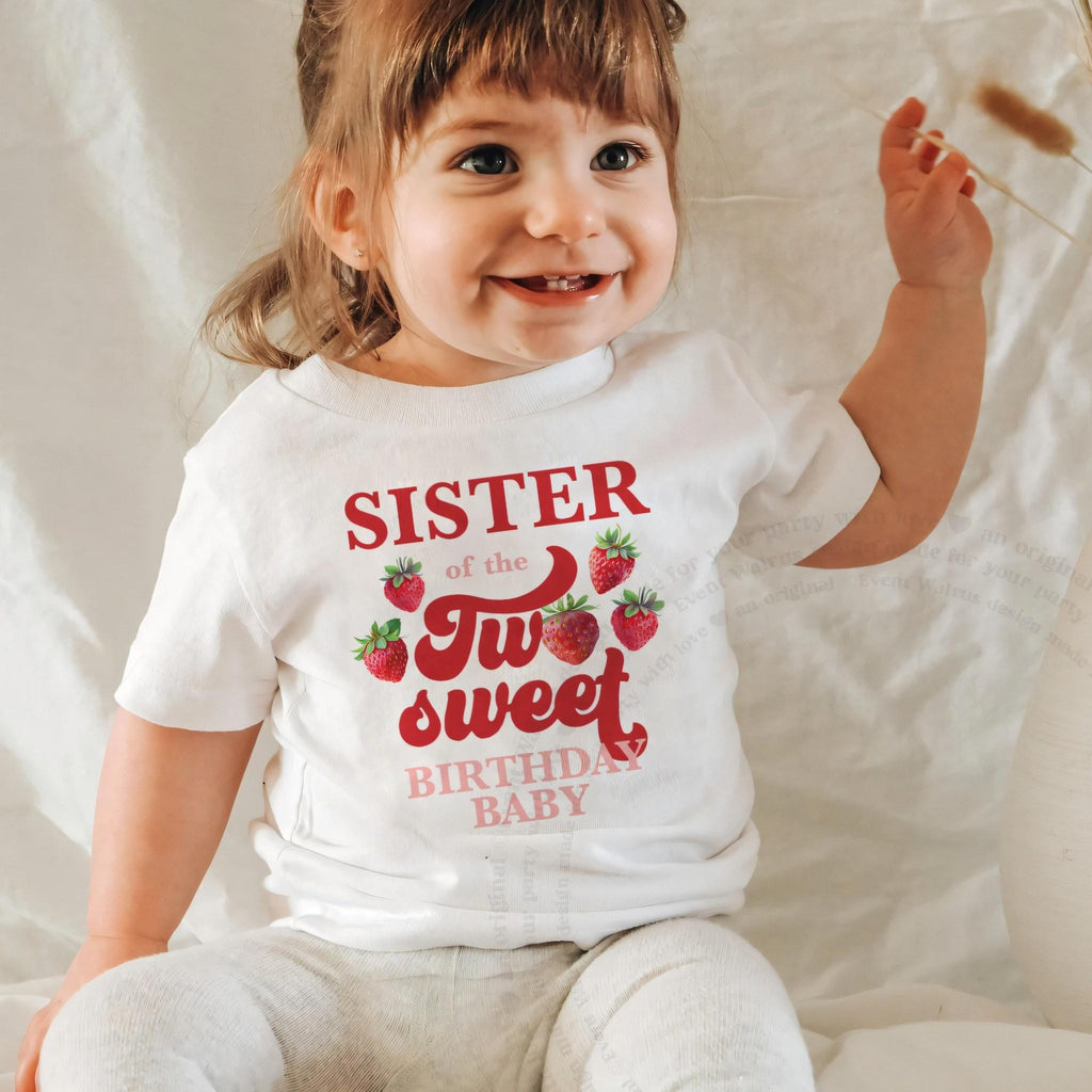Laughing baby girl in a white Sister of the Two Sweet baby tee.