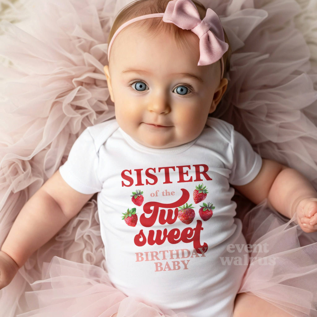 Baby girl with a pink bow on tulle in a white Sister of the Two Sweet bodysuit.