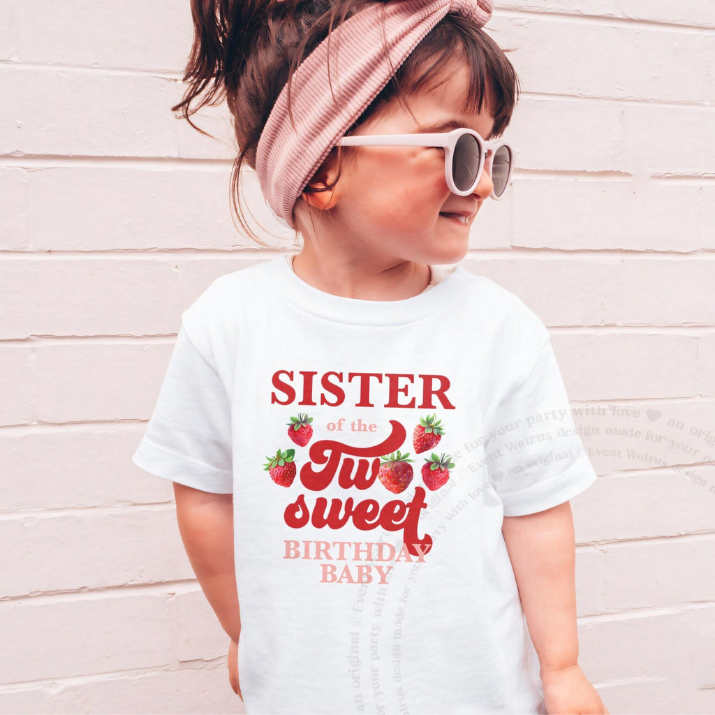 Girl in sunglasses and a pink headband wearing a white Sister of the Two Sweet shirt.