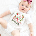 Baby girl with a pink bow lying in a white Two Sweet Birthday Sister bodysuit.