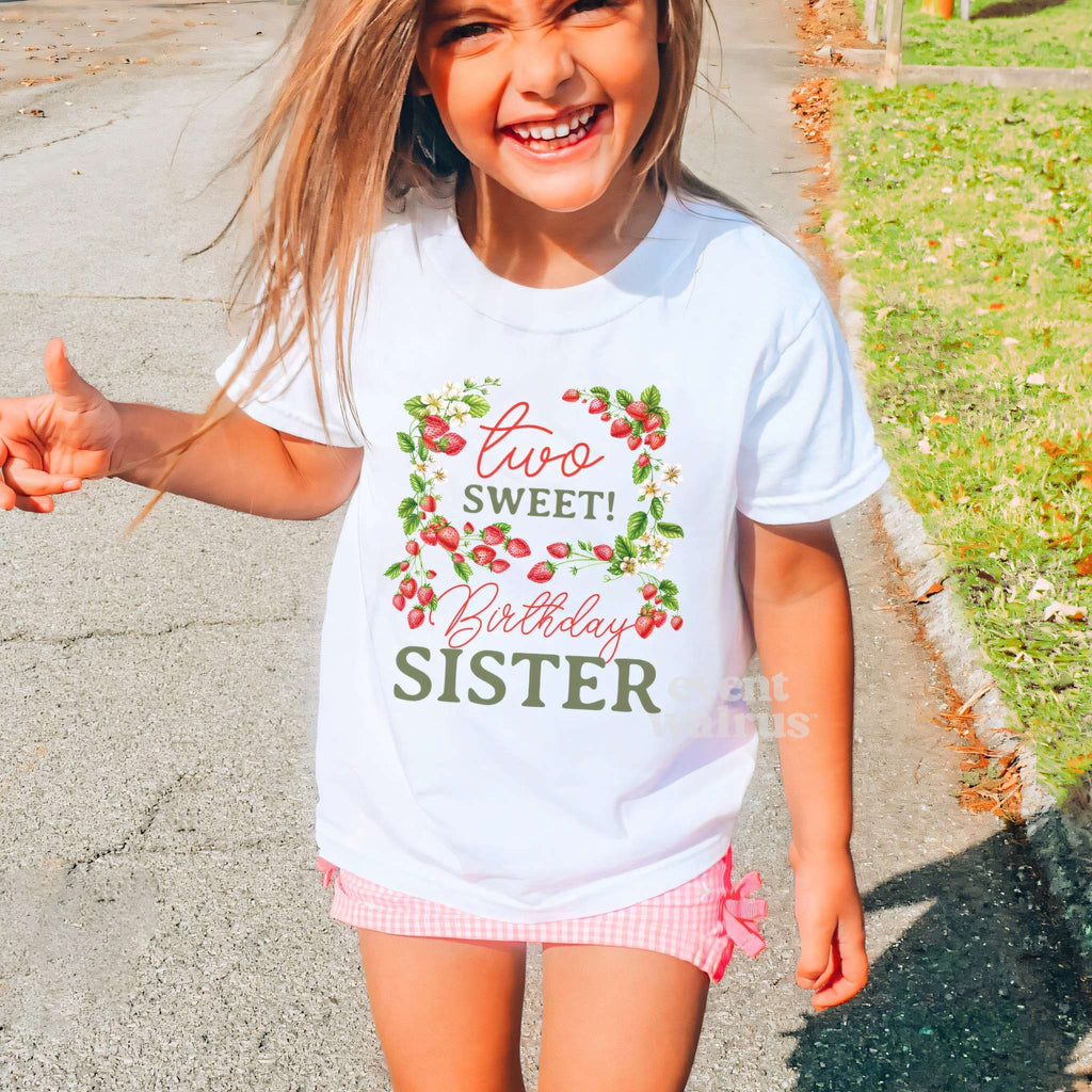 Laughing girl outdoors in a white Two Sweet Birthday Sister kids tee.