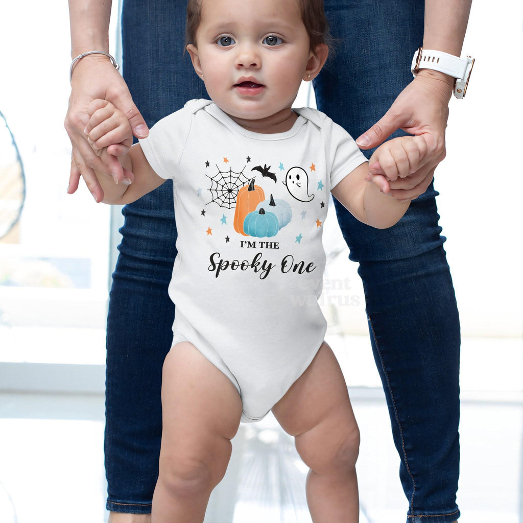 Baby taking steps while holding Mom's hands, in a white I'm the Spooky One bodysuit.