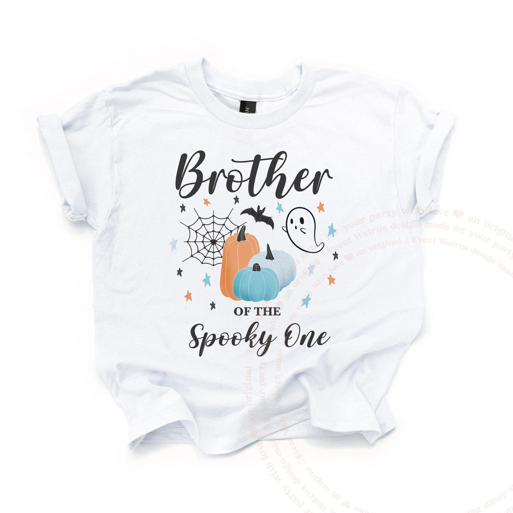 White Brother of the Spooky One kids tee laid flat, with teal and orange pumpkins and a ghost.