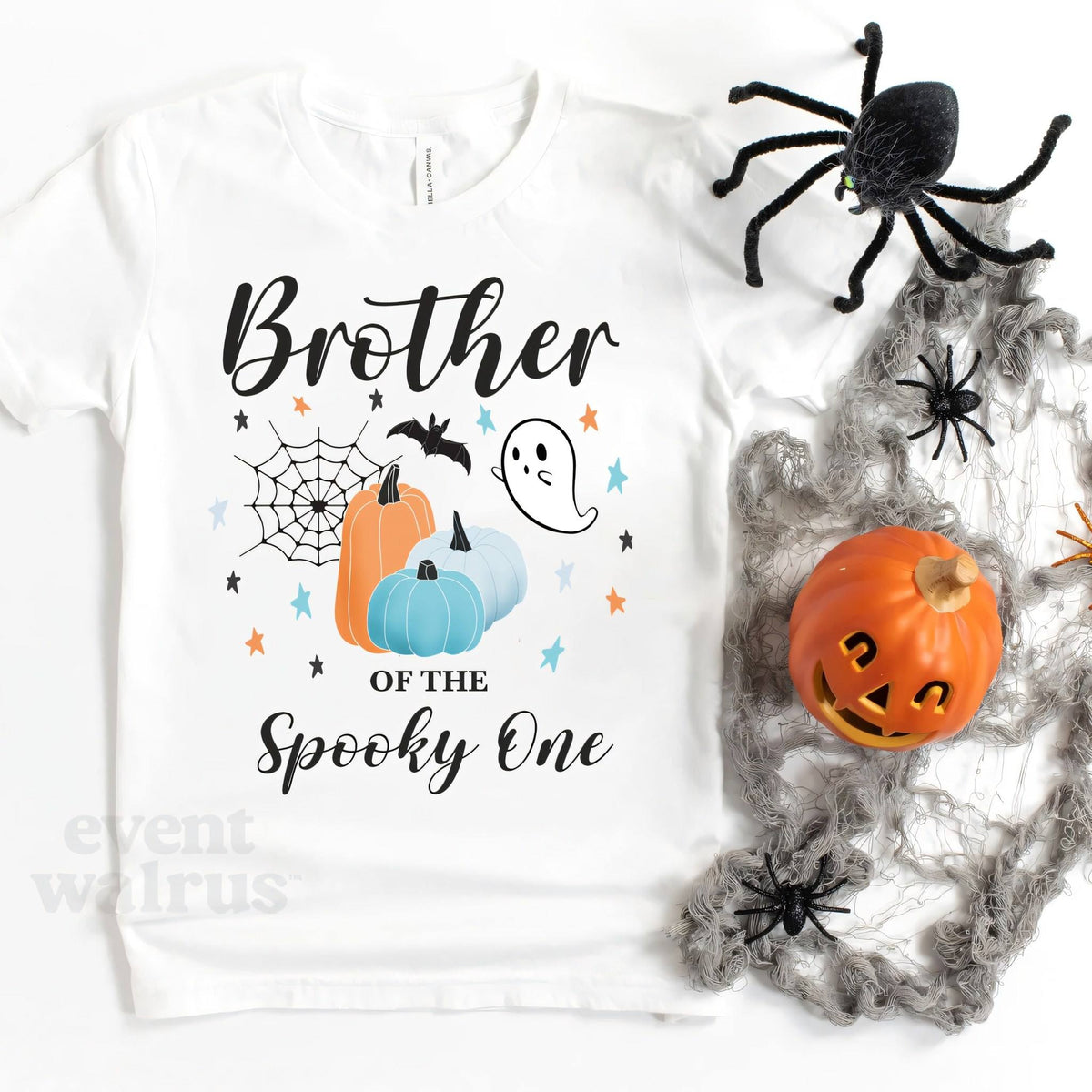 White Brother of the Spooky One kids tee laid flat with a jack-o'-lantern and spider webs.