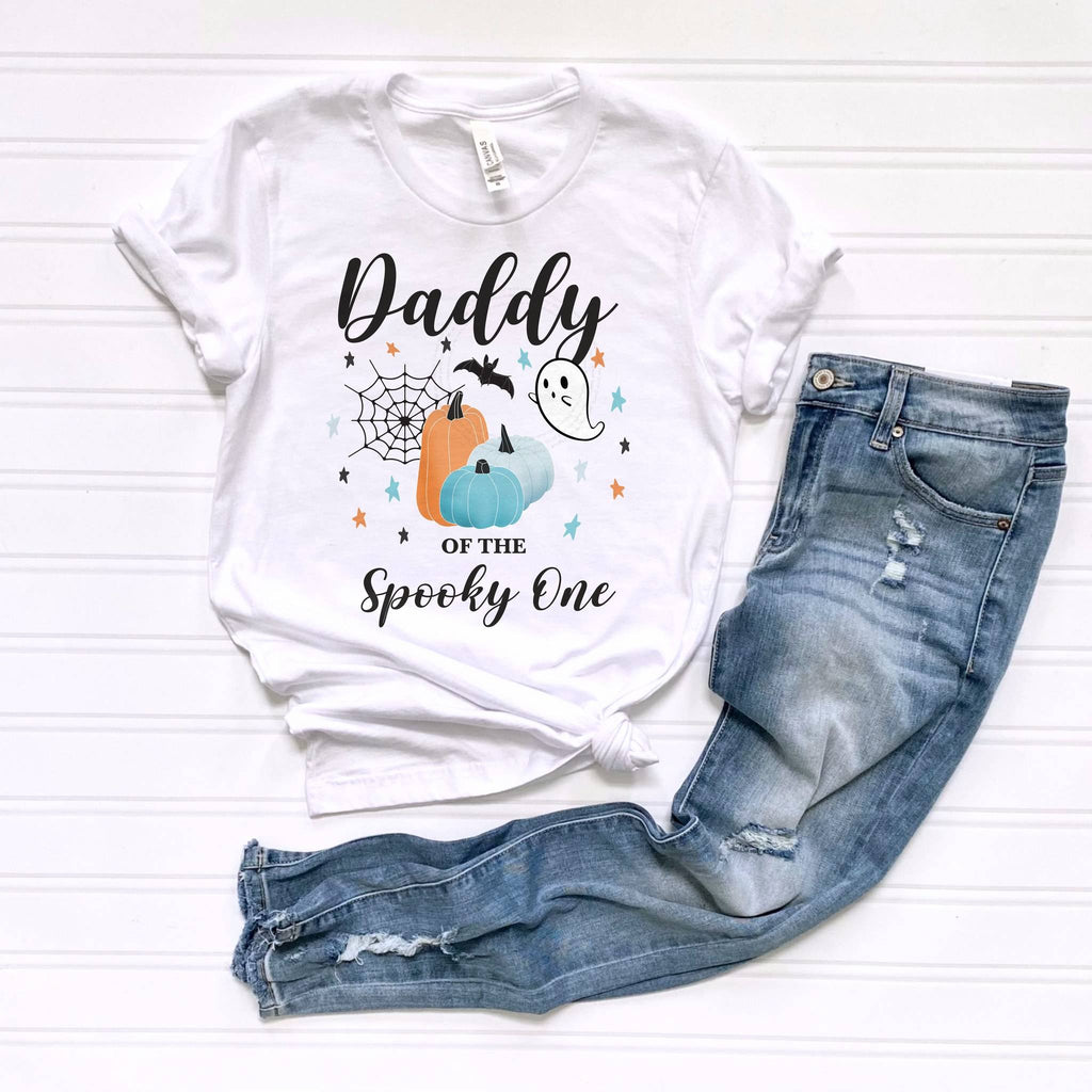White Daddy of the Spooky One tee laid flat beside jeans.