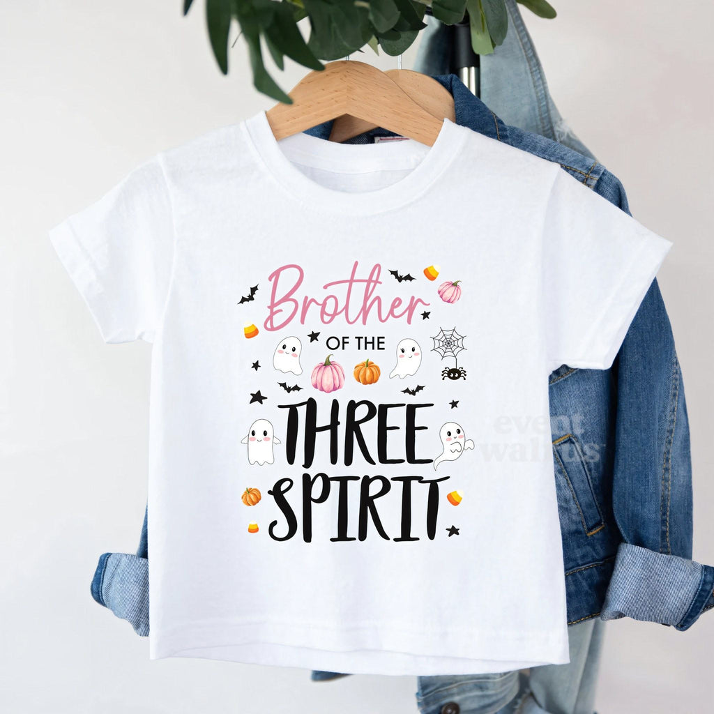 White Brother of the Three Spirit toddler tee on a hanger over a denim jacket.