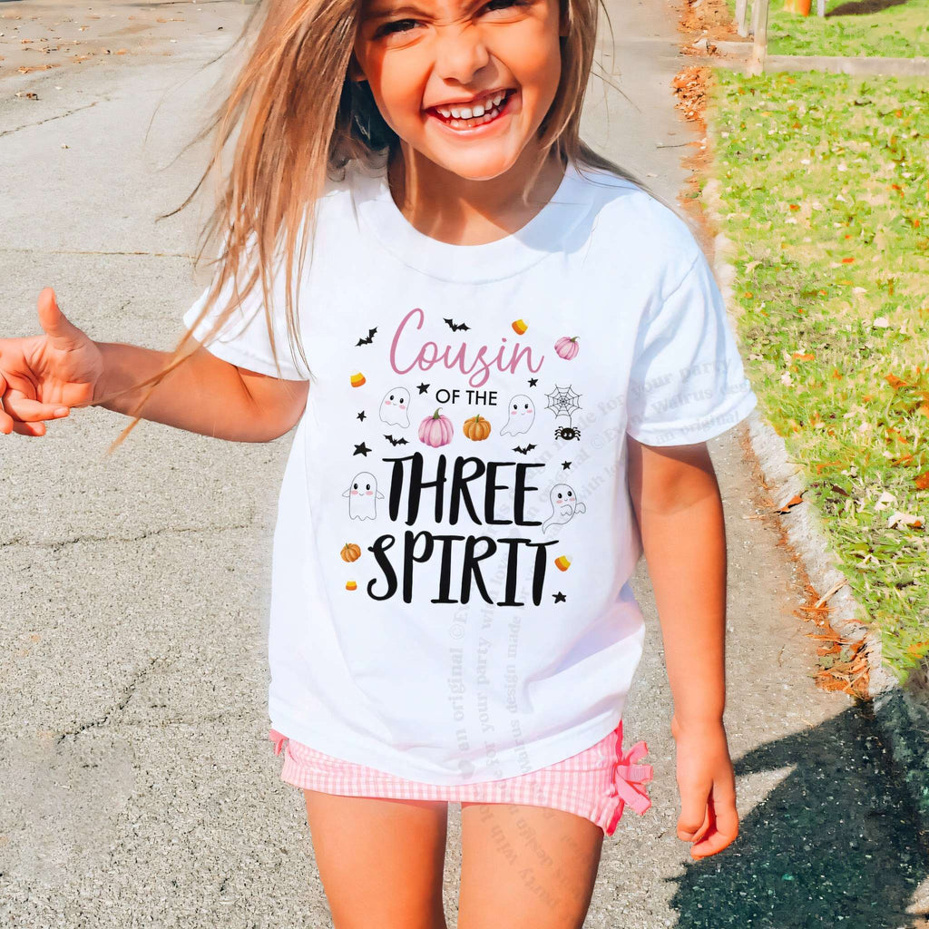 Laughing girl outdoors in a white Cousin of the Three Spirit kids tee.
