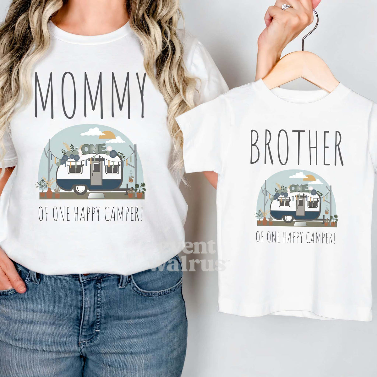White Brother of One Happy Camper tee on a hanger, held up by Mom in her Mommy shirt.