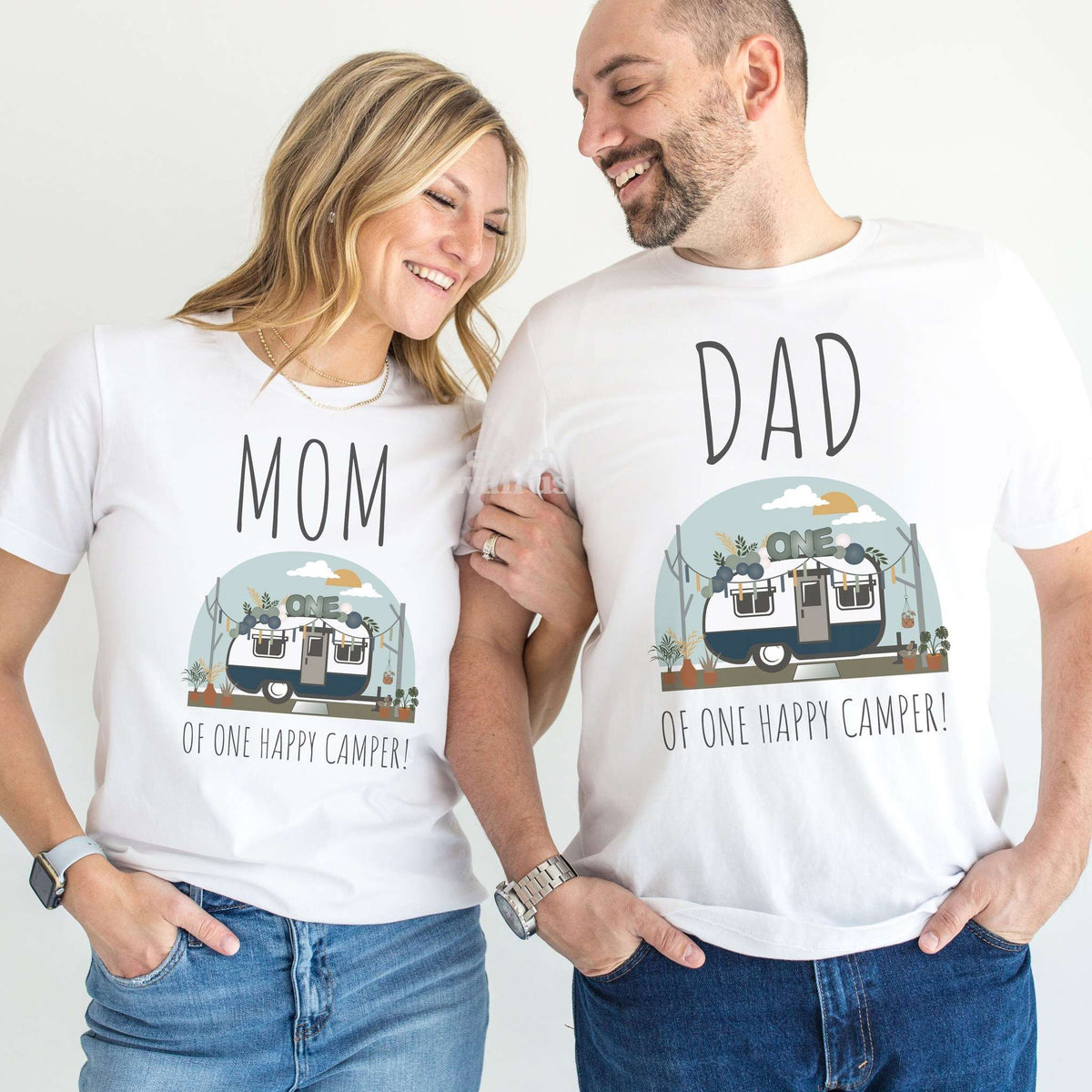 Mom and Dad laughing together in white Mom and Dad of One Happy Camper shirts.