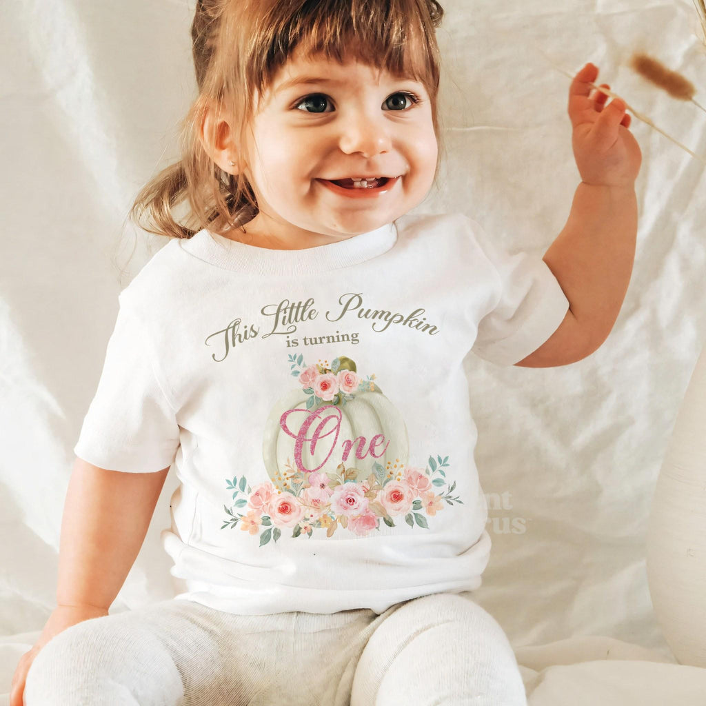 Laughing baby girl in a white blush rose Little Pumpkin baby tee.
