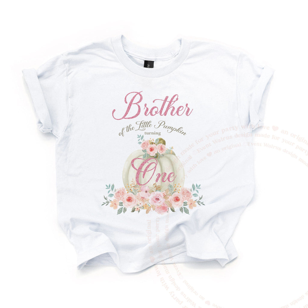 White Brother of the Little Pumpkin kids tee laid flat, with the cream pumpkin and pink glitter One.