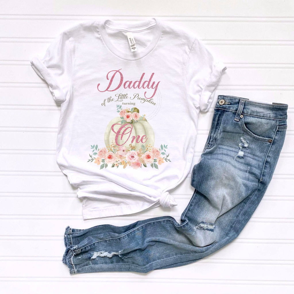 White Daddy of the Little Pumpkin tee laid flat beside jeans.