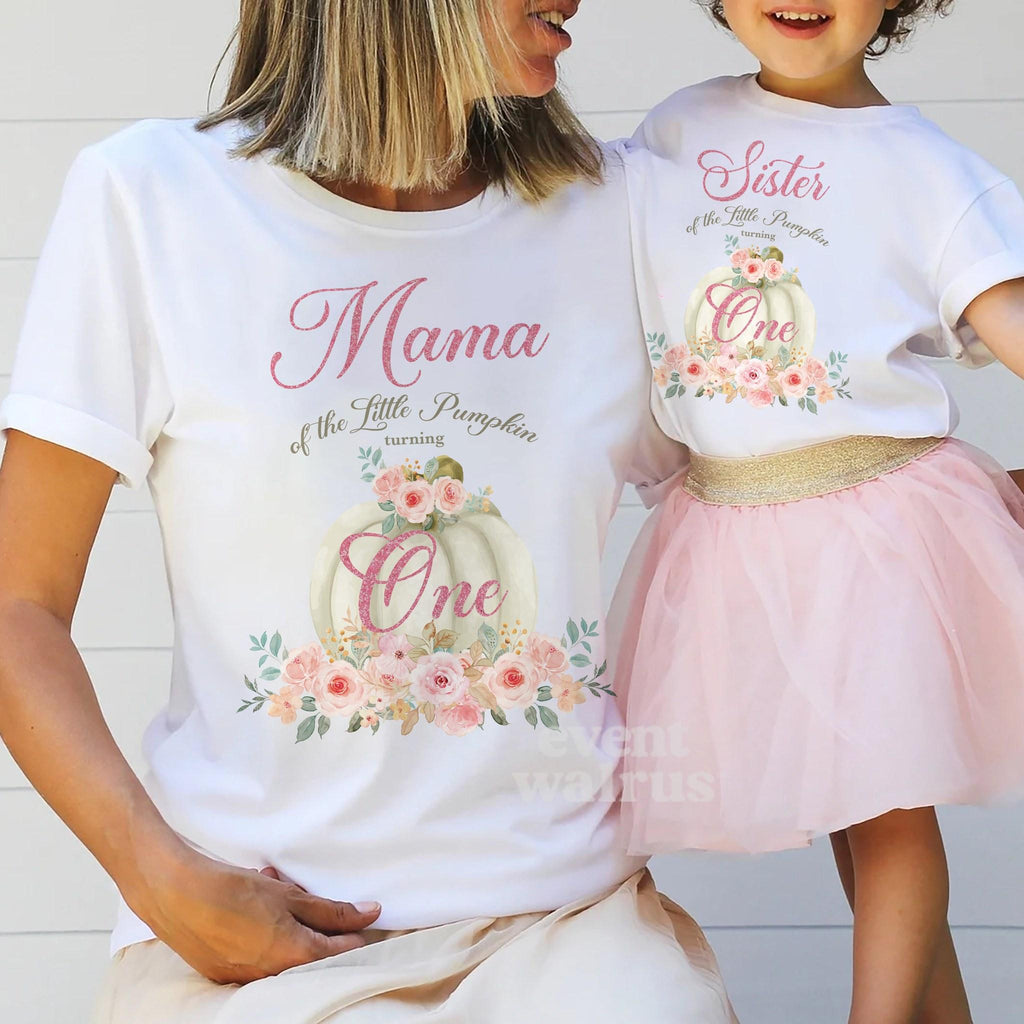 Mom holding hands with her little girl in a tutu, in white Mama and Sister Little Pumpkin shirts.