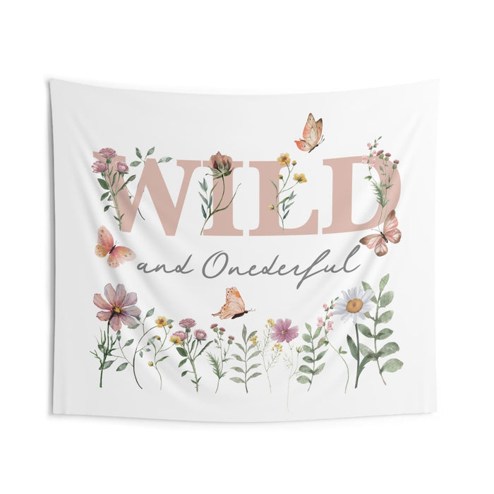 Wild and Onederful backdrop with pink WILD lettering, gray script, butterflies and a wildflower border on white.
