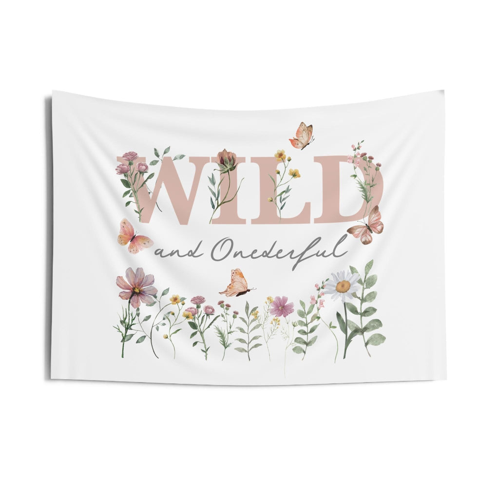 Small Wild and Onederful birthday backdrop hanging flat, pink and sage wildflowers on a white background.