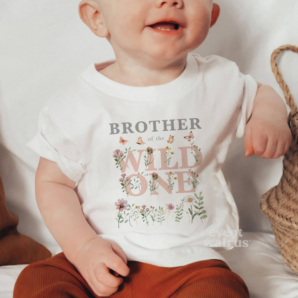 Little boy in a white Brother of the Wild One wildflower tee.