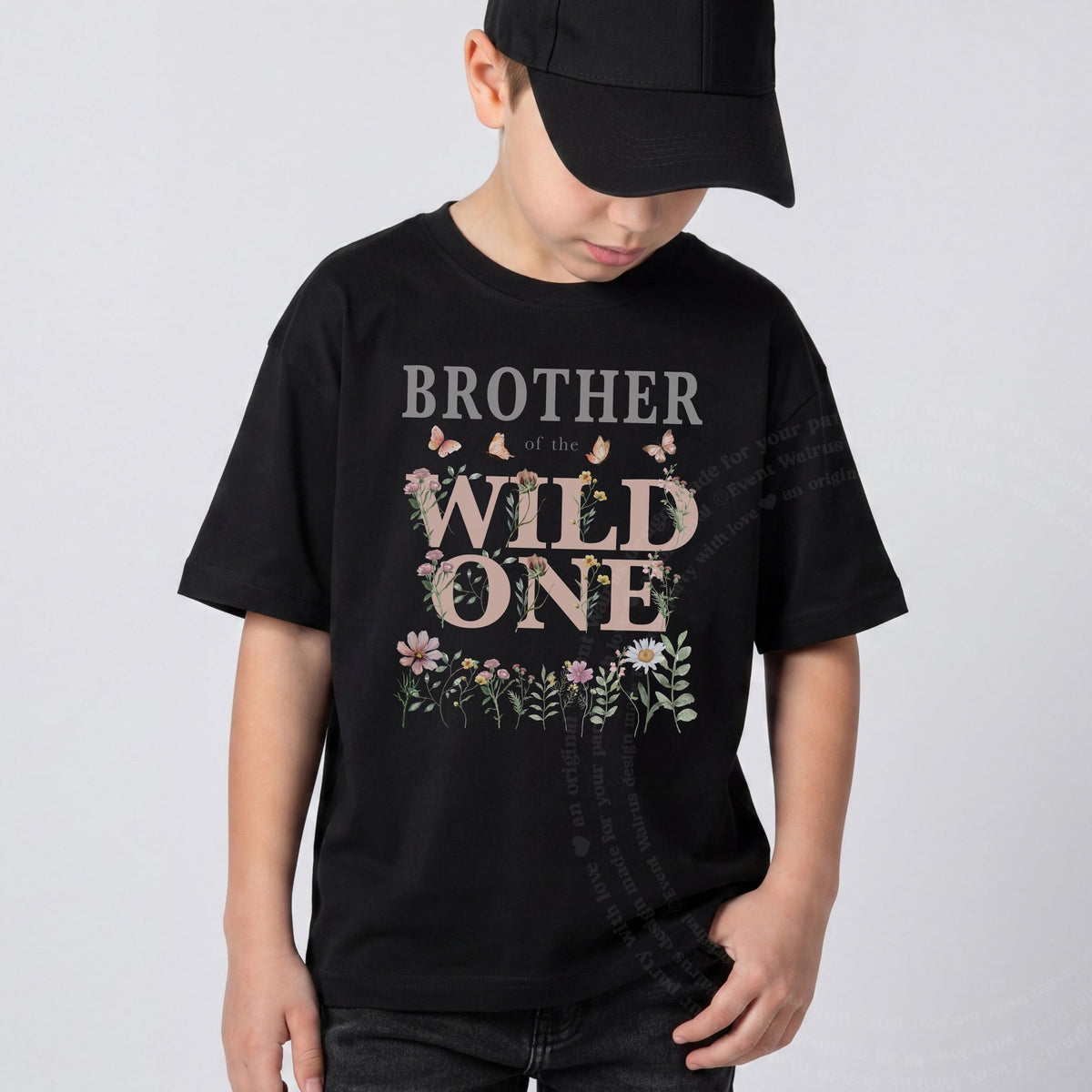 Boy in a black cap wearing a black Brother of the Wild One wildflower tee.