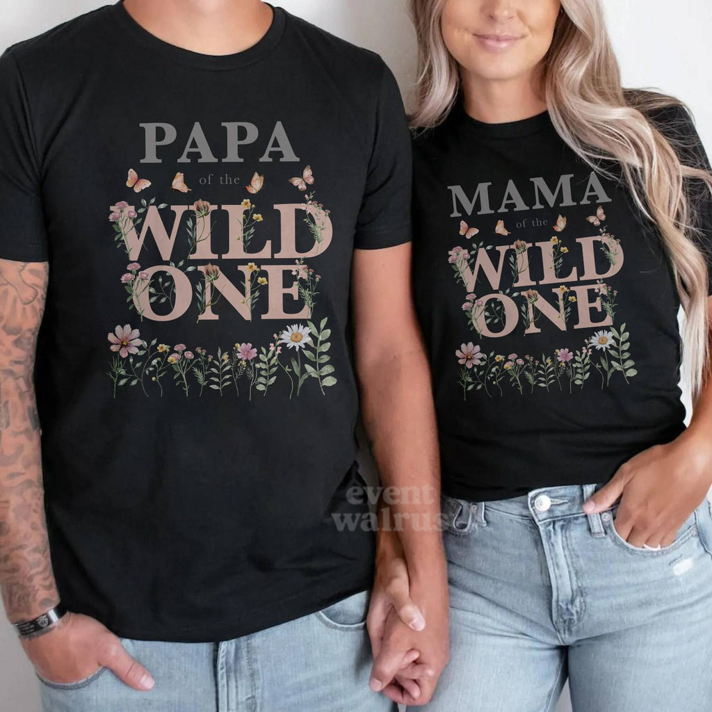 Couple in black Papa and Mama of the Wild One shirts with the pink wildflower design.