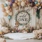 Wild ONE wood slice backdrop with dried wildflowers, pampas grass and cream balloons.
