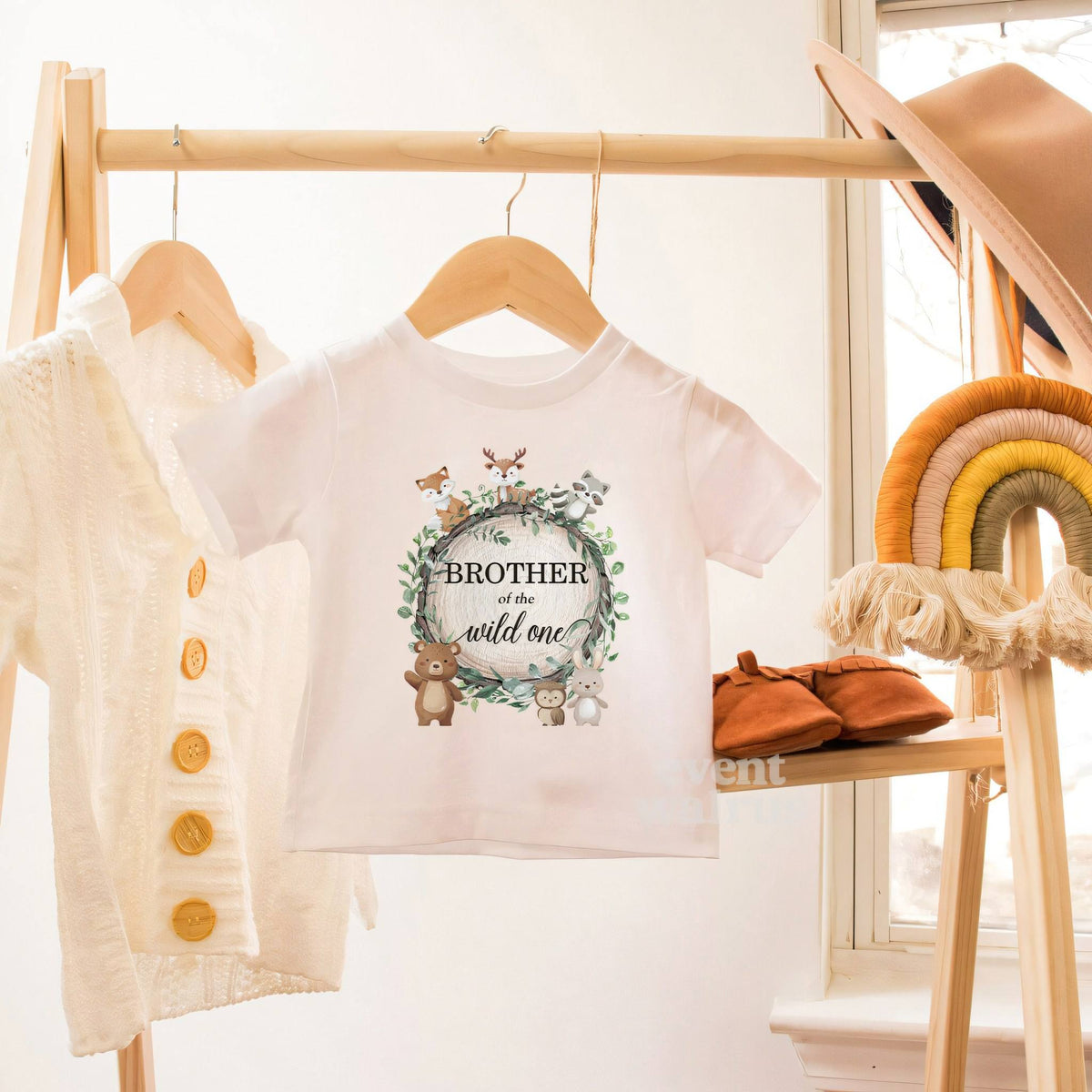 White Brother of the Wild One toddler tee on a wooden clothes rack.