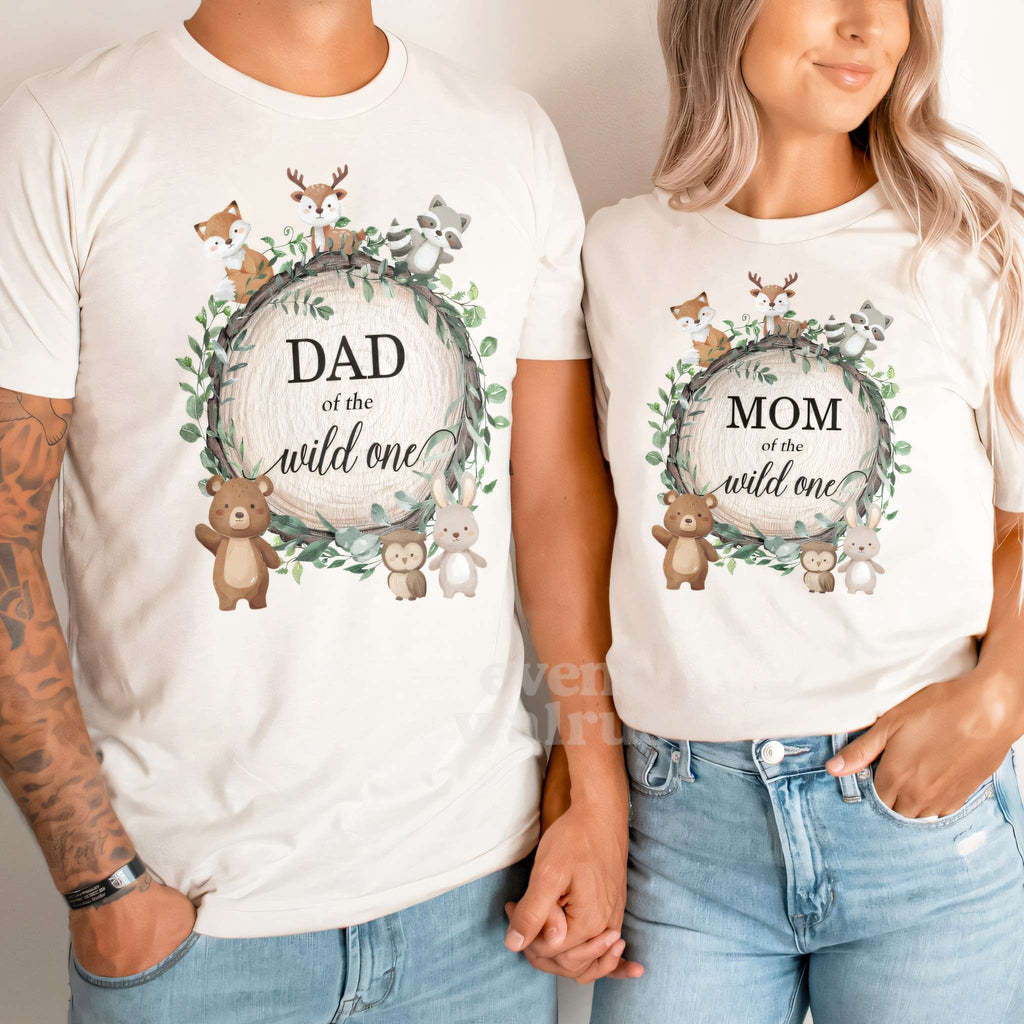 Dad and Mom side by side in white Dad and Mom of the Wild One woodland shirts.